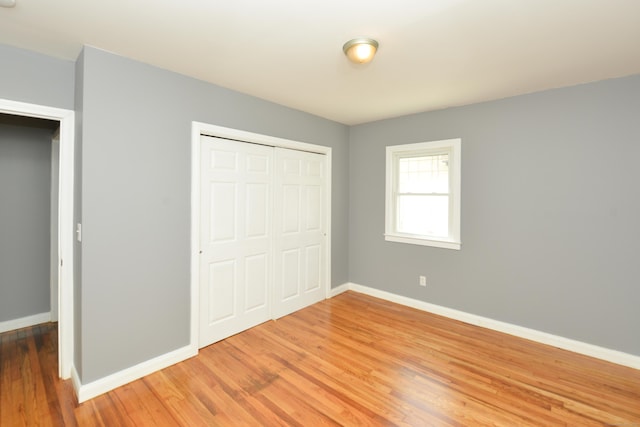 129 Tomlinson Ave, Plainville, CT 06062 - unfurnished bedroom featuring light wood-style flooring and a closet