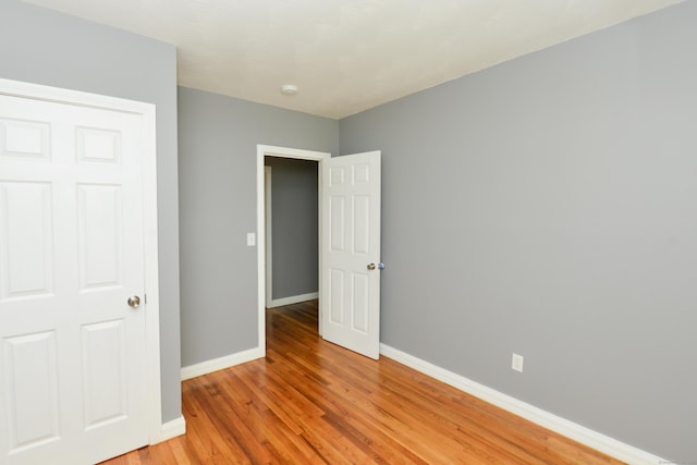 129 Tomlinson Ave, Plainville, CT 06062 - unfurnished bedroom with baseboards and light wood finished floors