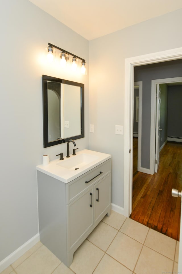 129 Tomlinson Ave, Plainville, CT 06062 - bathroom with a baseboard radiator, vanity, and tile patterned flooring