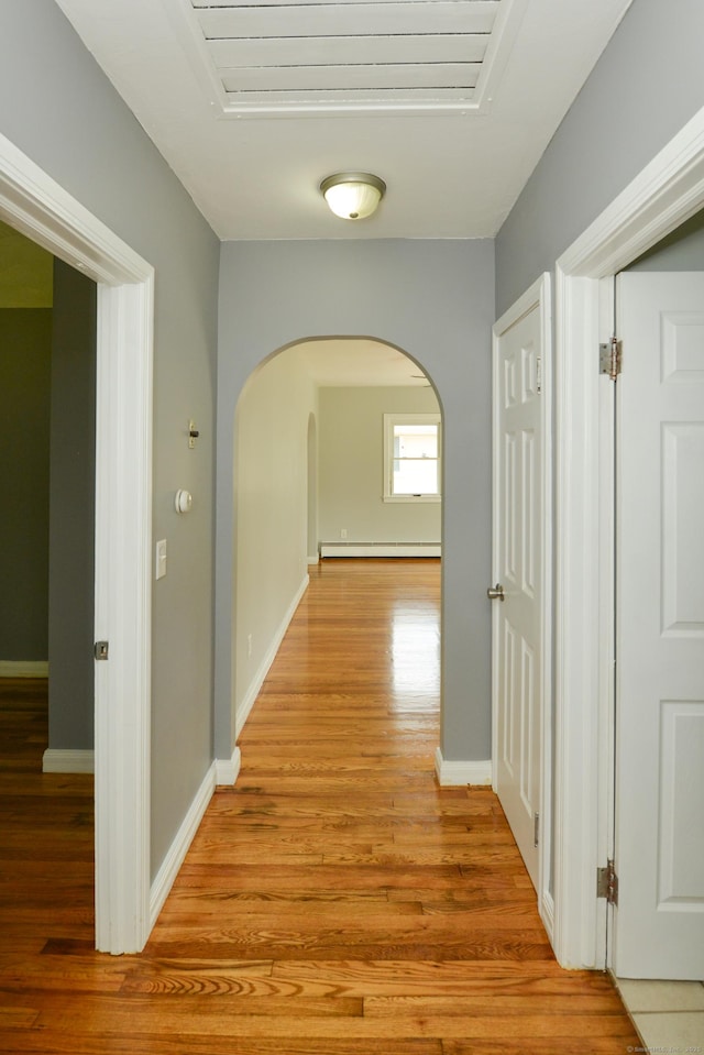 129 Tomlinson Ave, Plainville, CT 06062 - hallway with arched walkways, light wood-type flooring, and baseboard heating