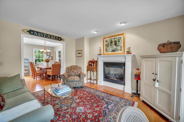 18 Overlook Ave, Middletown, CT 06457 - living room featuring a chandelier, a glass covered fireplace, and light wood-style flooring