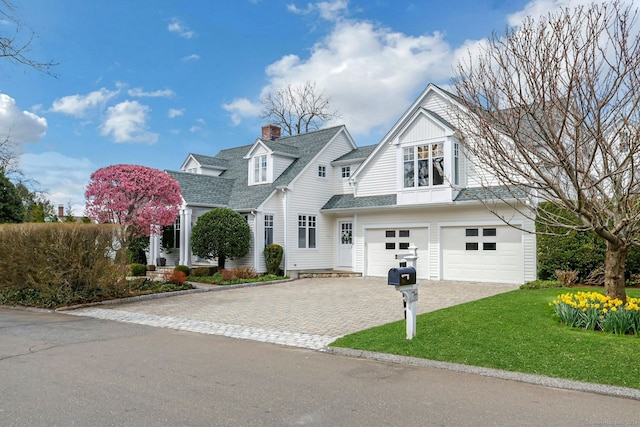 13 Bryan Rd, Norwalk, CT 06853 - view of front facade with a garage, decorative driveway, a front lawn, roof with shingles, and a chimney