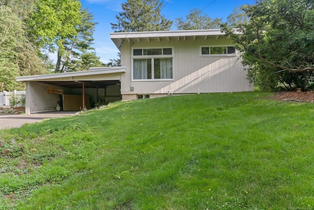 7 Calvin Rd, Wilton, CT 06897 - back of property featuring a lawn, a carport, and driveway