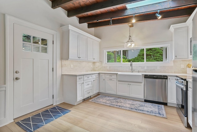 7 Calvin Rd, Wilton, CT 06897 - kitchen with stainless steel appliances, white cabinetry, light countertops, backsplash, and a wood ceiling with exposed beams