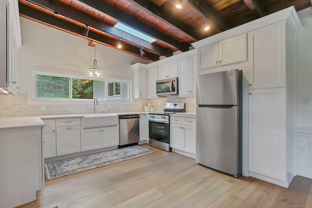 7 Calvin Rd, Wilton, CT 06897 - kitchen featuring stainless steel appliances, wood ceiling, decorative backsplash, white cabinetry, and rail lighting