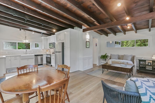 7 Calvin Rd, Wilton, CT 06897 - dining area featuring light wood-style flooring, wooden ceiling, a wainscoted wall, and track lighting