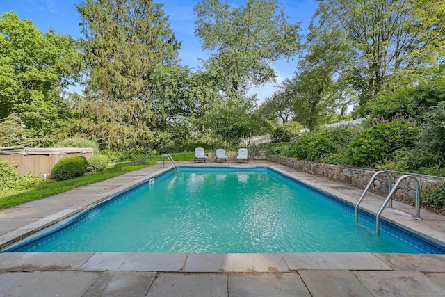 7 Calvin Rd, Wilton, CT 06897 - view of pool with a jacuzzi, view of scattered trees, and a patio area