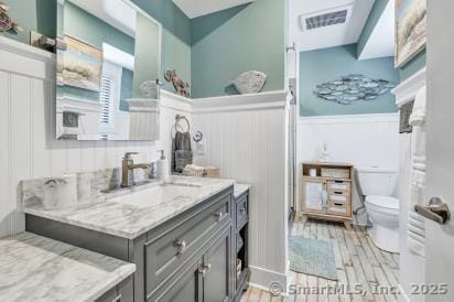 92 Seminole Ln Unit B, Stratford, CT 06614 - full bathroom with vanity, a wainscoted wall, wood finished floors, and a decorative wall