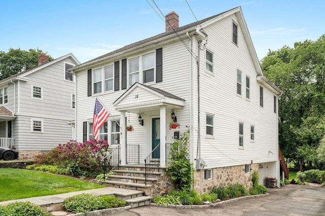 14 Maple St, Darien, CT 06820 - view of front of property with a chimney and a front lawn