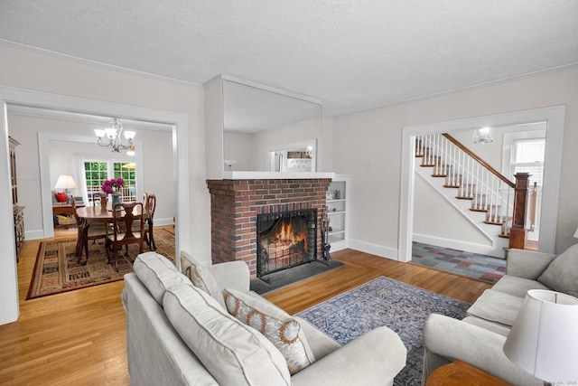 14 Maple St, Darien, CT 06820 - living area featuring wood finished floors, a chandelier, stairway, and a fireplace