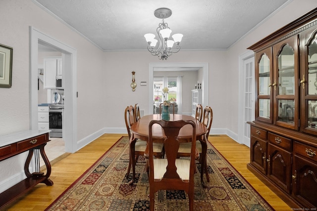 14 Maple St, Darien, CT 06820 - dining room featuring a chandelier, a textured ceiling, light wood finished floors, and crown molding