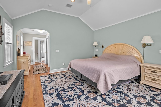 14 Maple St, Darien, CT 06820 - bedroom with light wood-style flooring, arched walkways, vaulted ceiling, ornamental molding, and ceiling fan