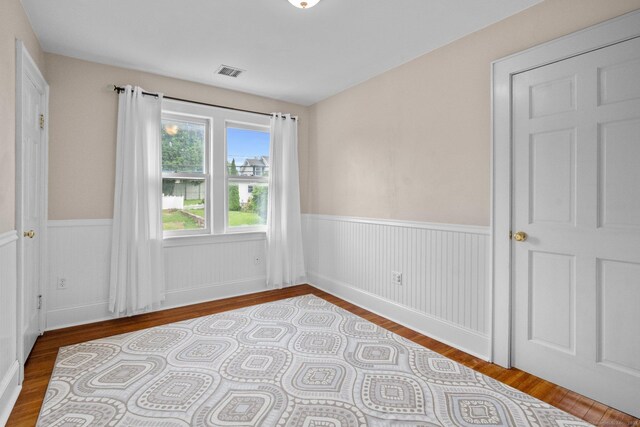 14 Maple St, Darien, CT 06820 - empty room with wood finished floors and wainscoting