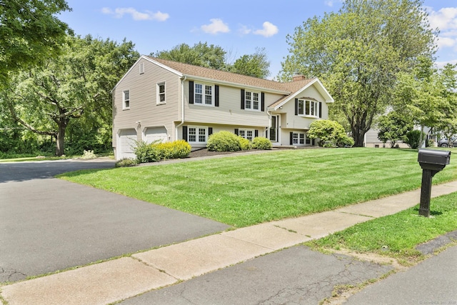 66 Pinnacle Rd, Bristol, CT 06010 - view of front of house featuring a chimney, driveway, a garage, and a front yard