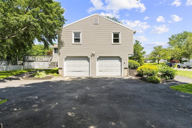 66 Pinnacle Rd, Bristol, CT 06010 - view of side of home featuring an attached garage, driveway, and a deck