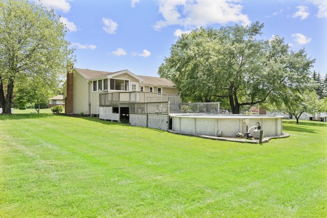 66 Pinnacle Rd, Bristol, CT 06010 - back of property with a wooden deck, a chimney, an outdoor pool, and a lawn