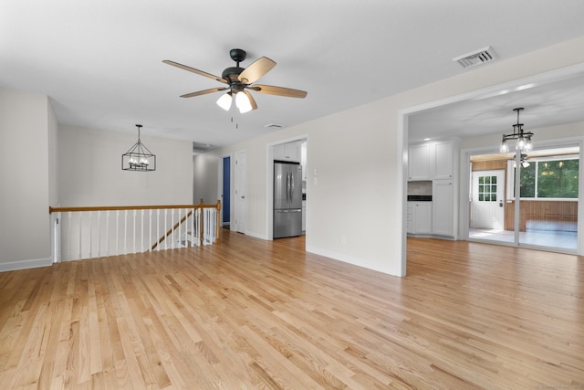 66 Pinnacle Rd, Bristol, CT 06010 - unfurnished living room with a chandelier, light wood-style flooring, and a ceiling fan