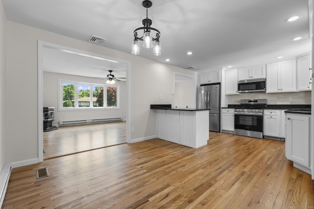 66 Pinnacle Rd, Bristol, CT 06010 - kitchen with appliances with stainless steel finishes, dark countertops, baseboard heating, light wood-style flooring, and backsplash