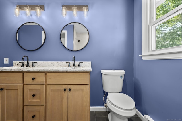 66 Pinnacle Rd, Bristol, CT 06010 - bathroom with healthy amount of natural light, double vanity, tile patterned floors, and a baseboard heating unit