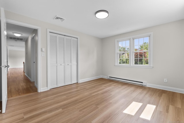 66 Pinnacle Rd, Bristol, CT 06010 - unfurnished bedroom with baseboard heating, light wood finished floors, and a closet