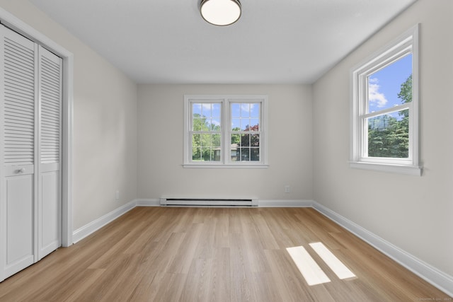 66 Pinnacle Rd, Bristol, CT 06010 - unfurnished bedroom with baseboard heating, light wood finished floors, and a closet