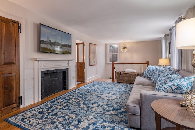 850 Noank Rd, Groton, CT 06355 - living area with wood finished floors, a chandelier, and a tile fireplace