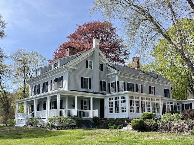 850 Noank Rd, Groton, CT 06355 - back of house with a chimney, covered porch, a lawn, and a sunroom