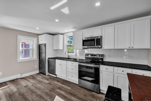 300 Central Ave, Norwich, CT 06360 - kitchen with appliances with stainless steel finishes, backsplash, dark countertops, white cabinetry, and recessed lighting