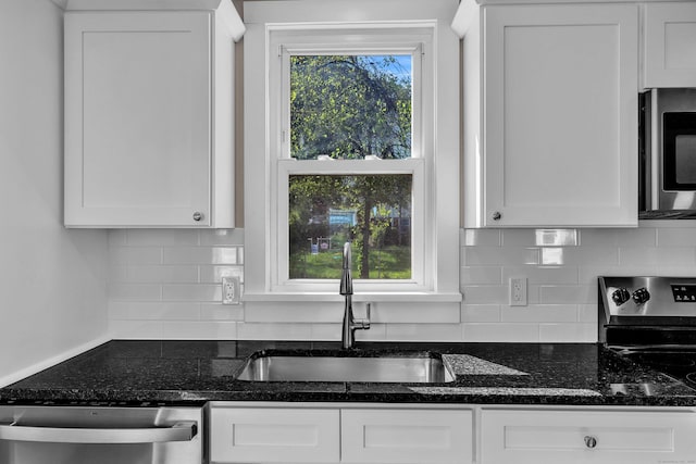 300 Central Ave, Norwich, CT 06360 - kitchen with stainless steel appliances, white cabinets, dark stone countertops, and backsplash