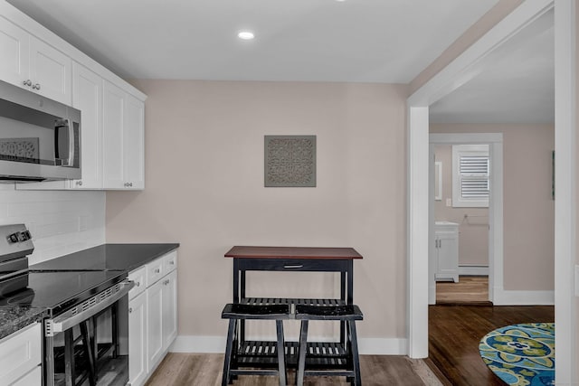300 Central Ave, Norwich, CT 06360 - kitchen with stainless steel appliances, dark wood-type flooring, decorative backsplash, white cabinets, and recessed lighting