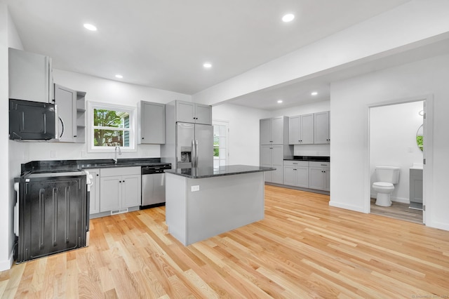 339 Main St, Wallingford, CT 06492 - kitchen featuring appliances with stainless steel finishes, open shelves, light wood-style floors, a kitchen island, and recessed lighting