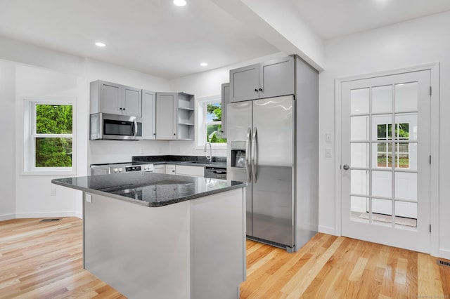 339 Main St, Wallingford, CT 06492 - kitchen featuring stainless steel appliances, gray cabinets, open shelves, dark stone countertops, and plenty of natural light
