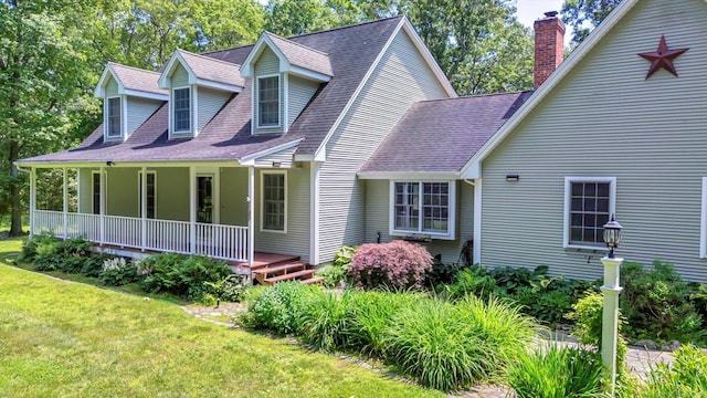 42 Woodmont Cir, East Haddam, CT 06423 - view of home's exterior featuring a porch, a chimney, a yard, and roof with shingles