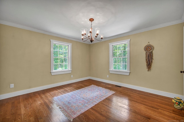 42 Woodmont Cir, East Haddam, CT 06423 - empty room with plenty of natural light, ornamental molding, a chandelier, and wood finished floors