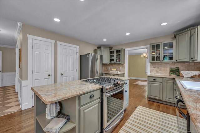 42 Woodmont Cir, East Haddam, CT 06423 - kitchen with appliances with stainless steel finishes, a chandelier, a kitchen island, open shelves, and tasteful backsplash