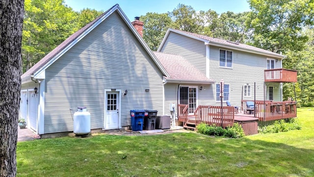 42 Woodmont Cir, East Haddam, CT 06423 - rear view of property with a chimney, a yard, a wooden deck, and a garage