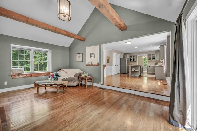 42 Woodmont Cir, East Haddam, CT 06423 - living area featuring light wood-type flooring, beamed ceiling, plenty of natural light, and high vaulted ceiling