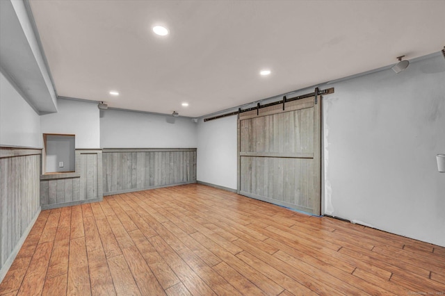 42 Woodmont Cir, East Haddam, CT 06423 - below grade area featuring a barn door, wood finished floors, and recessed lighting