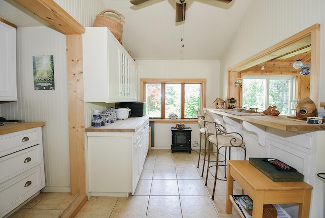 279 Pratt St, Winchester, CT 06098 - kitchen featuring plenty of natural light, white cabinets, glass insert cabinets, light tile patterned floors, and lofted ceiling
