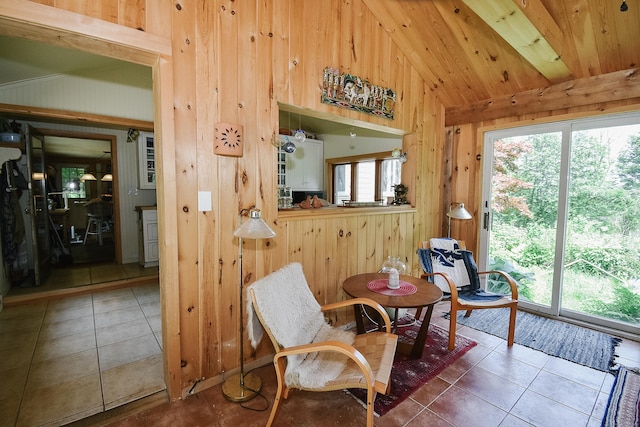 279 Pratt St, Winchester, CT 06098 - living area with vaulted ceiling, wood walls, and tile patterned floors