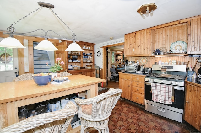 279 Pratt St, Winchester, CT 06098 - kitchen with stainless steel range with gas stovetop, decorative light fixtures, brick patterned floors, and dark countertops