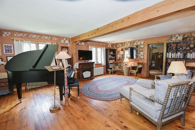 279 Pratt St, Winchester, CT 06098 - living room with radiator heating unit, healthy amount of natural light, hardwood / wood-style floors, and beam ceiling