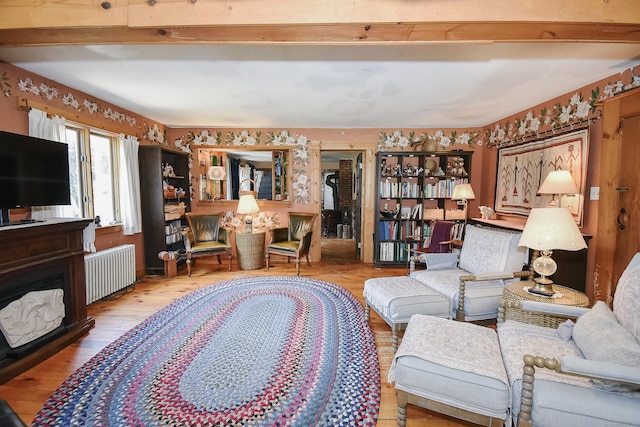 279 Pratt St, Winchester, CT 06098 - living room featuring radiator, wood finished floors, and beam ceiling