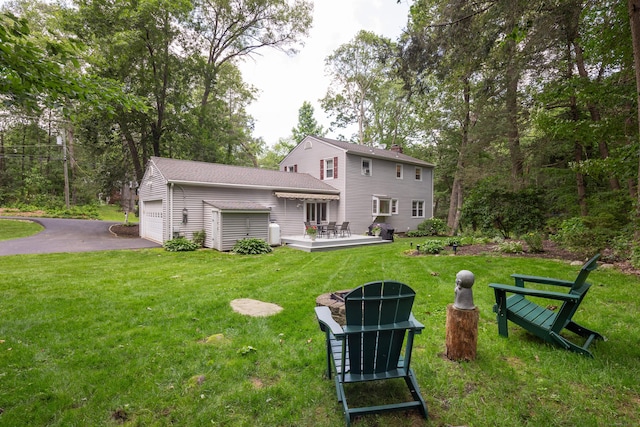 1 Whippoorwill Ln, Brookfield, CT 06804 - back of property featuring a yard, a garage, asphalt driveway, and a wooden deck