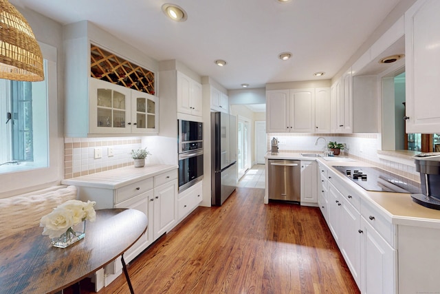 1 Whippoorwill Ln, Brookfield, CT 06804 - kitchen with black appliances, white cabinets, glass insert cabinets, wood finished floors, and recessed lighting