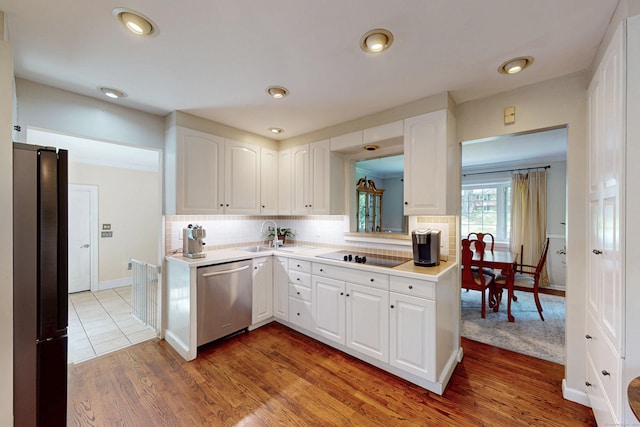 1 Whippoorwill Ln, Brookfield, CT 06804 - kitchen featuring black appliances, light countertops, white cabinets, tasteful backsplash, and recessed lighting