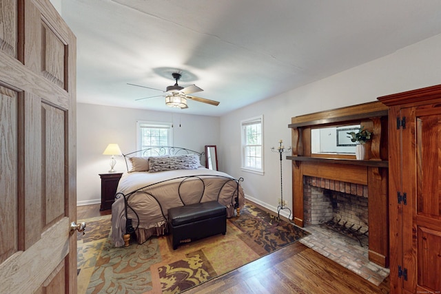 1 Whippoorwill Ln, Brookfield, CT 06804 - bedroom featuring multiple windows, a fireplace with flush hearth, and wood finished floors