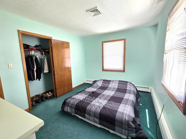 51 Peppermint Ln, Bristol, CT 06010 - carpeted bedroom with multiple windows, baseboard heating, a textured ceiling, and a closet