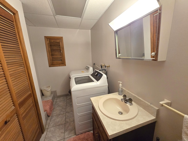 51 Peppermint Ln, Bristol, CT 06010 - bathroom with washer and clothes dryer, a paneled ceiling, vanity, tile patterned flooring, and a closet