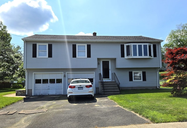 51 Peppermint Ln, Bristol, CT 06010 - bi-level home with an attached garage, driveway, a front lawn, a chimney, and entry steps